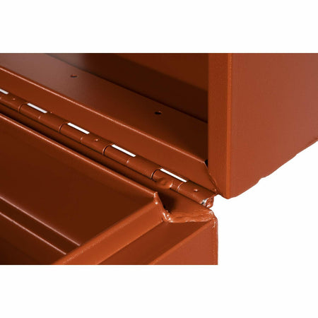 Close-up of a welded hinge on a reddish-brown Crescent JOBOX chest. The metal hinge connects the lid to the body, showcasing durable construction and tamper-resistant design for secure jobsite storage.