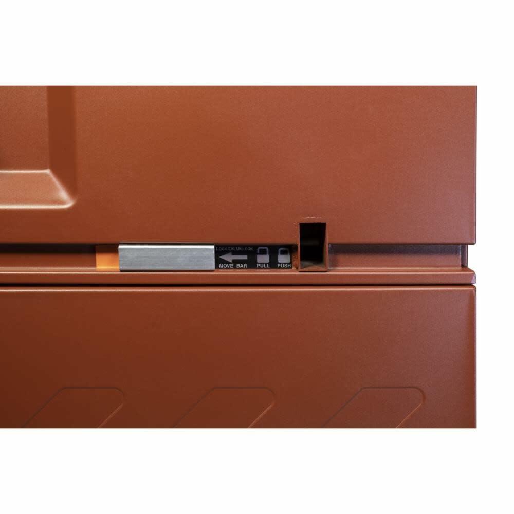 Close-up of a brown metal toolbox with visible branding on a white background