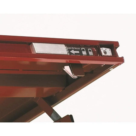 A macro detail of the Site-Vault™ security system on the JOBOX lid, featuring the bolt-cutter proof housing, lock/unlock indicators, and the recessed padlock port.