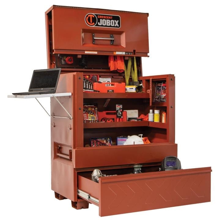 Crescent JOBOX 48-inch Site-Vault heavy-duty piano box jobsite storage cabinet, open with tools and a laptop on a side shelf. The drawer is pulled out, showing more tools.