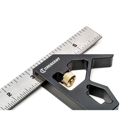 Close-up perspective of the black square head clamped onto the silver blade, focusing on the white Crescent logo and the brass knurled nut mechanism.