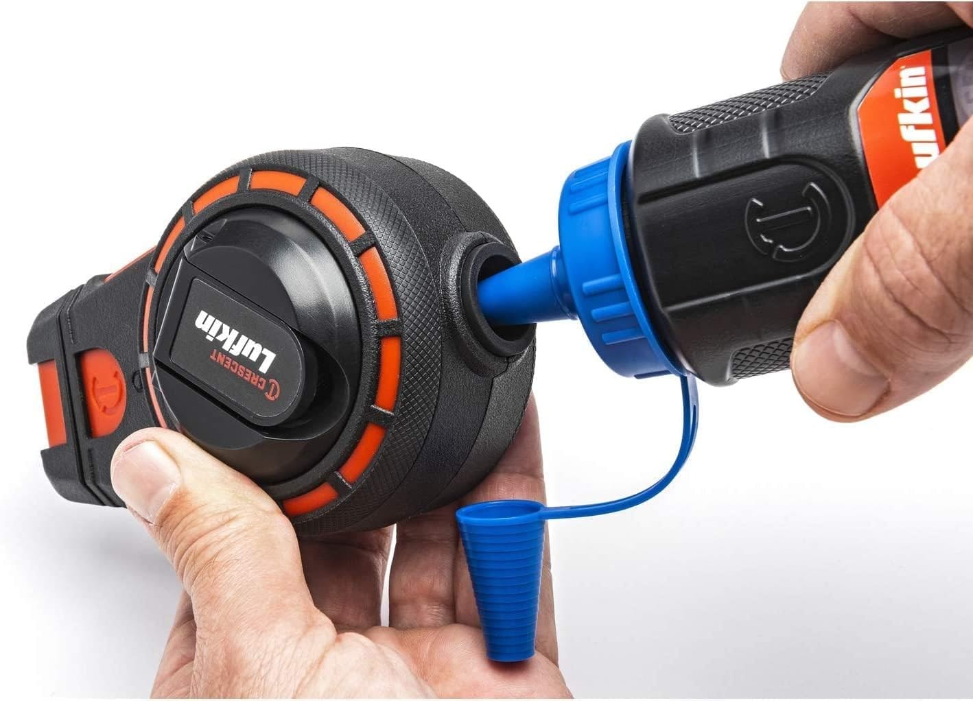 Action shot demonstrating the clean refill process using the one-way chalk refill valve on the Crescent Lufkin 100-foot reel for efficient layout setup.