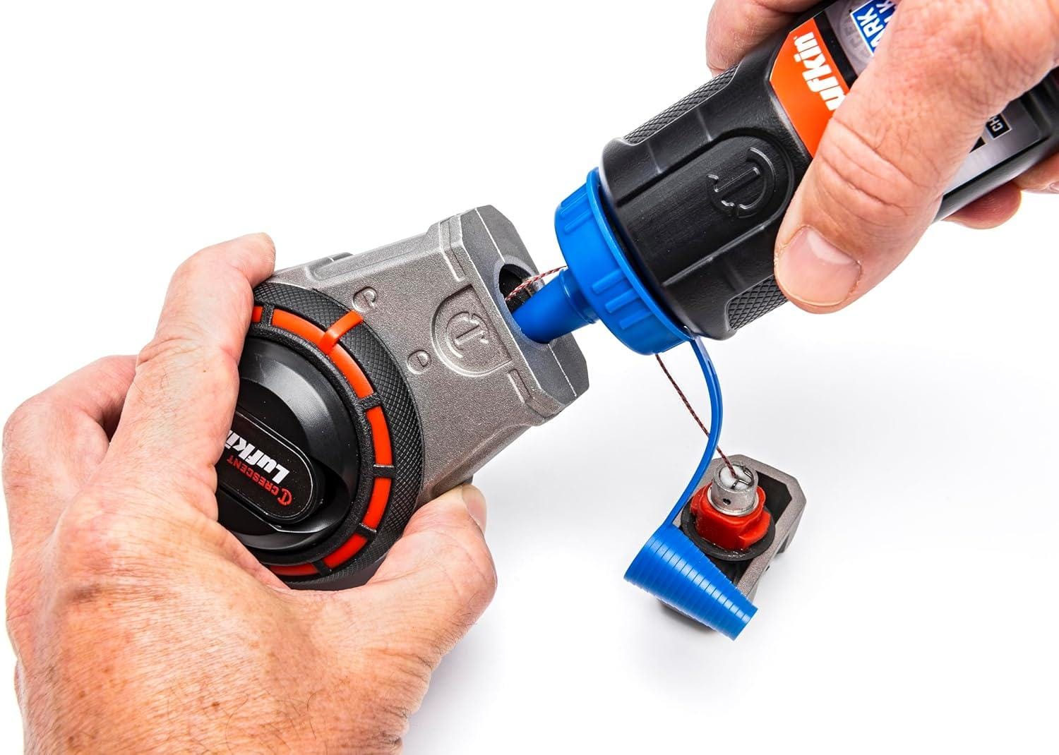 A person demonstrates refilling the Crescent Lufkin chalk reel using the one-way valve on a Lufkin chalk bottle.