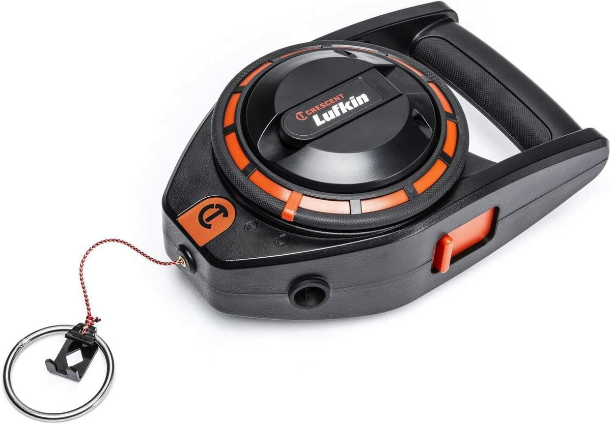 A three-quarter studio shot of the Crescent Lufkin 150-foot construction chalk reel, showing its black and orange body, D-handle, and the braided line with the combo hook/ring extended.