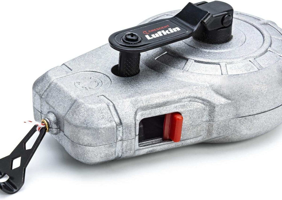 Close-up of the Crescent Lufkin aluminum chalk reel identifying the side-access sliding refill door for quick chalk replenishment and the protective dock for the end hook.