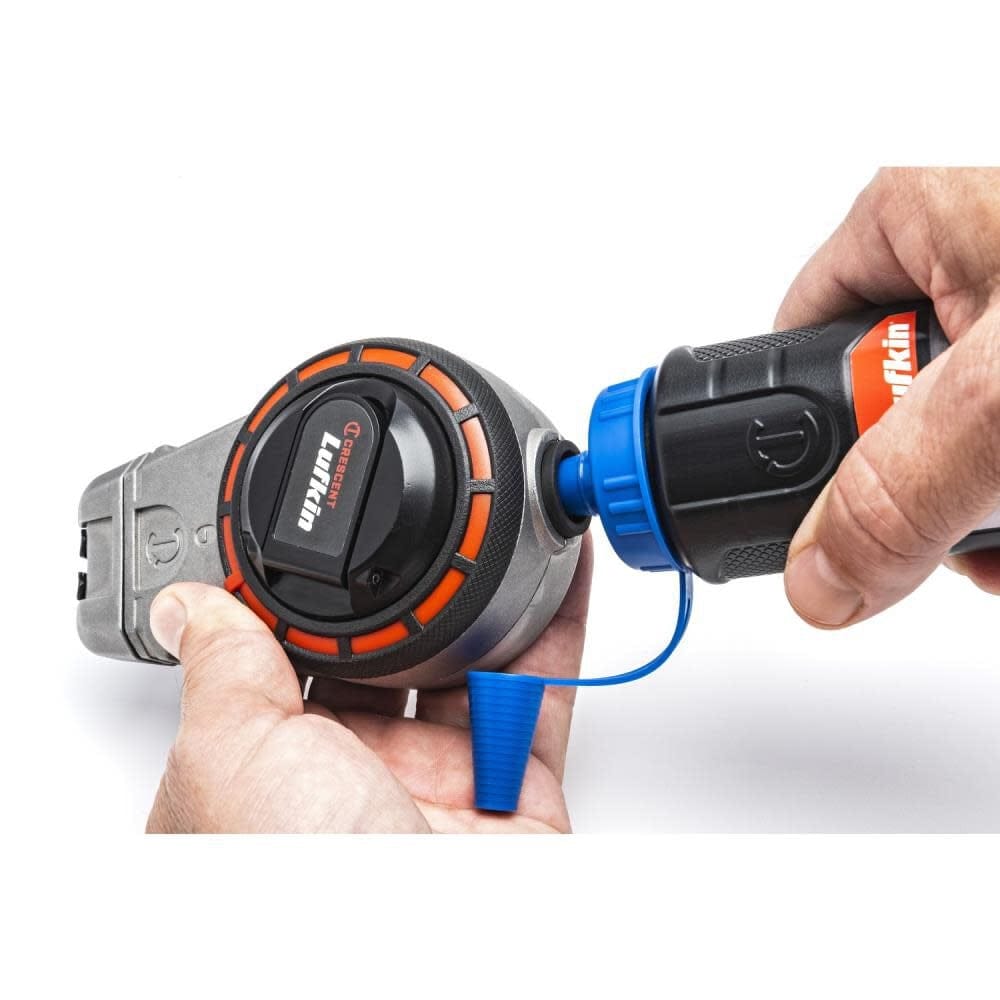 Action shot demonstrating the mess-free refill process for the Crescent Lufkin chalk reel using the one-way fill valve to add professional red chalk.