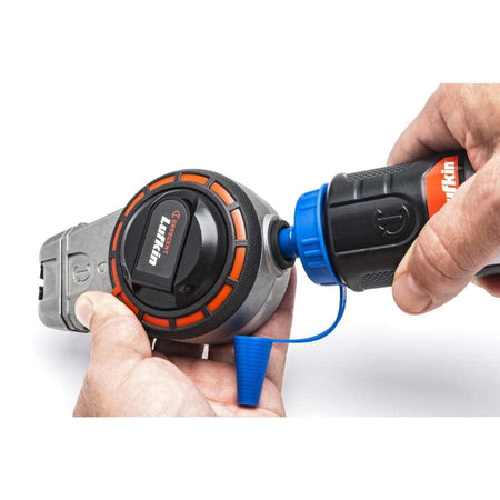 Action shot demonstrating the mess-free refill process for the Crescent Lufkin chalk reel using the one-way fill valve to add professional red chalk.