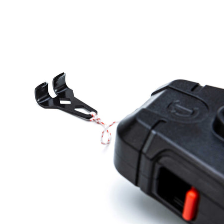 Close-up detail of the heavy-duty metal end hook attached to the reinforced braided nylon string of the Crescent Lufkin CLP100B 100-foot chalk reel.