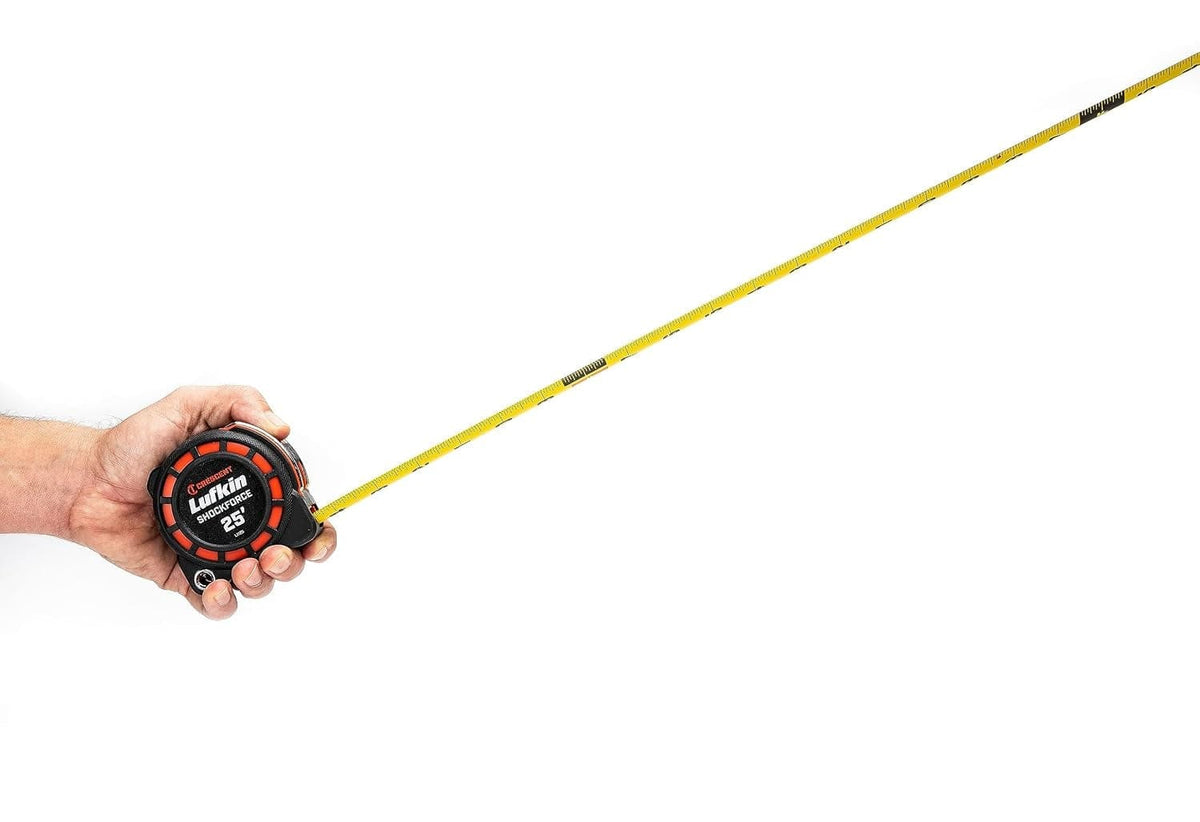 An action photograph of a hand holding the compact Crescent Lufkin Shockforce G1 tape measure with the blade extended, demonstrating the standout capability and lightweight design for professional jobsite use.