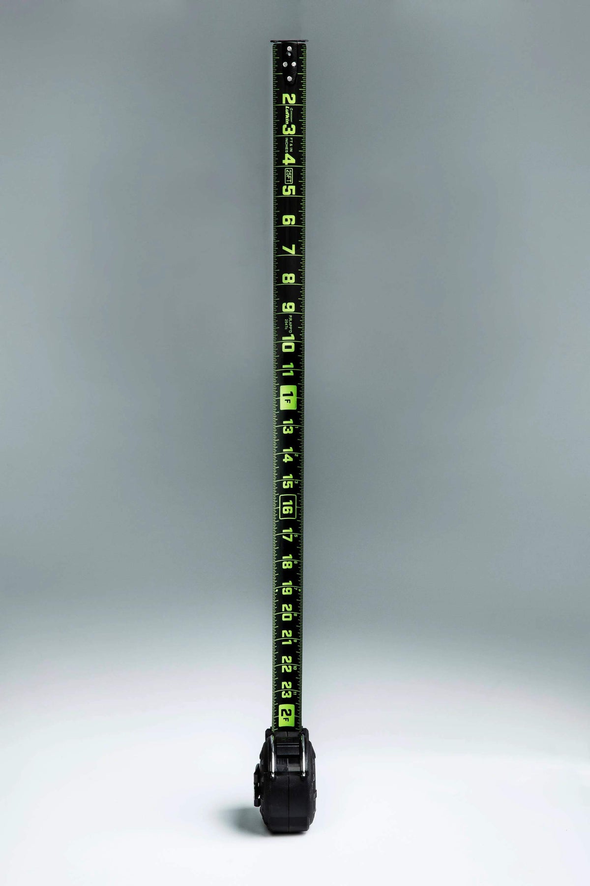 Vertical view of the fully extended Crescent Lufkin 35-foot Nite Eye blade, highlighting the high-visibility neon green markings against the matte black steel surface.