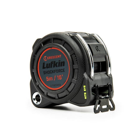 Angled view of the rugged black tape measure case showing the steel tether point and textured rubber grip.