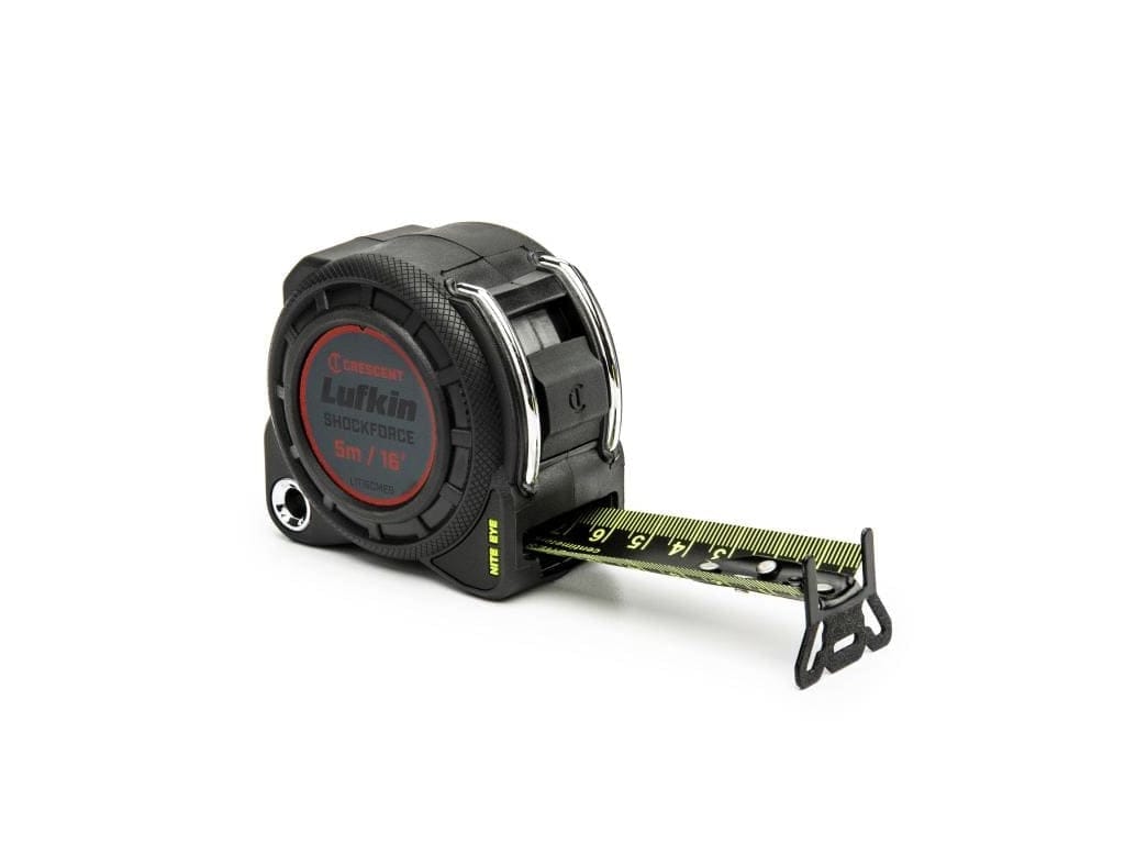 Studio view of the black Shockforce tape measure with the Nite Eye high-visibility blade extended showing metric and imperial markings.