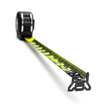 Perspective view of the tape measure blade extended towards the viewer showcasing the matte black finish with high-visibility green markings and the oversized end hook.