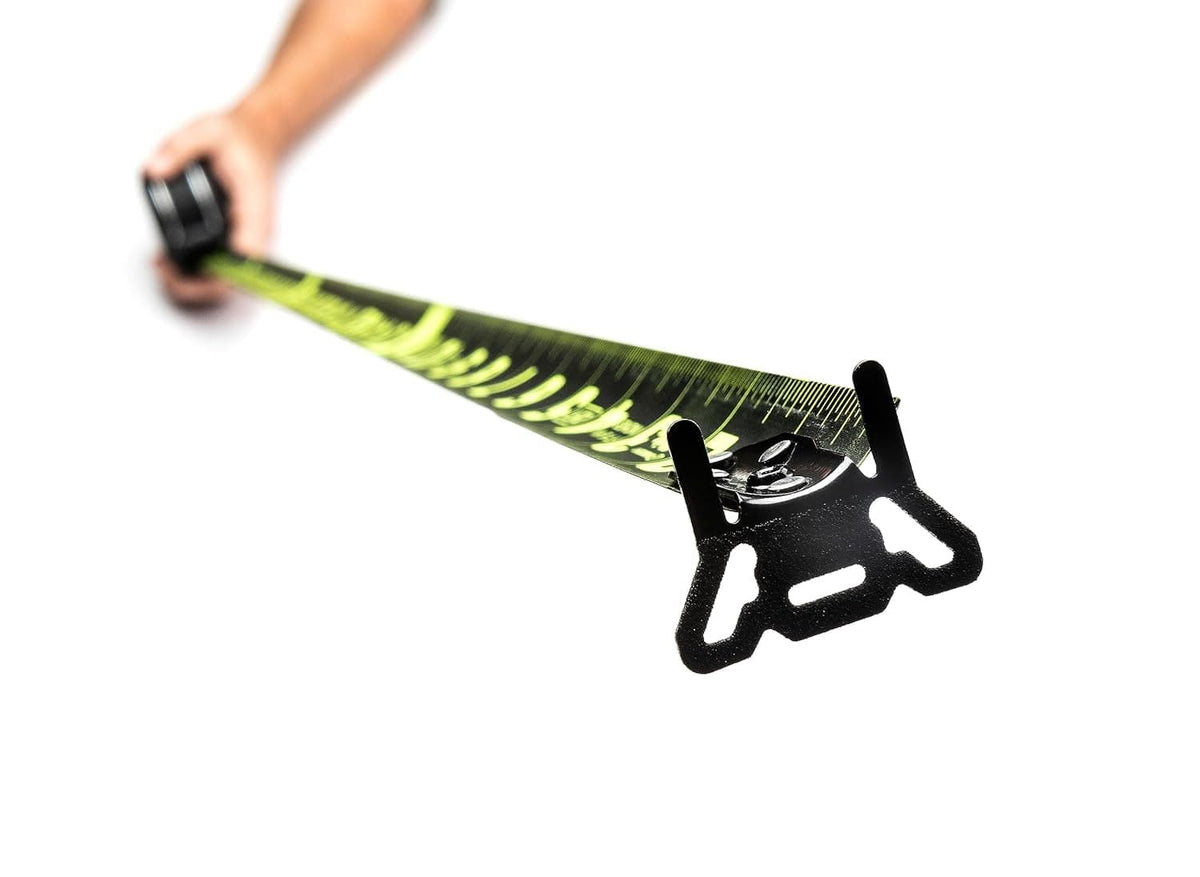 Extreme close-up from the endhook looking down the length of the Crescent Lufkin Nite Eye tape measure blade, showcasing the high-contrast green markings against the matte black nylon coating.