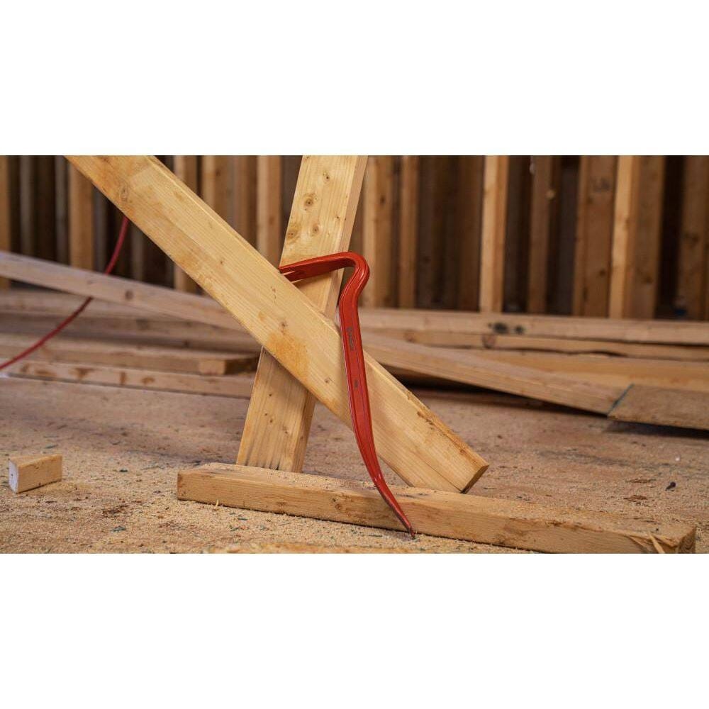 The Crescent 18-inch steel wrecking pry bar securely wedged into a wooden frame assembly, demonstrating the leverage provided by its curved gooseneck design.