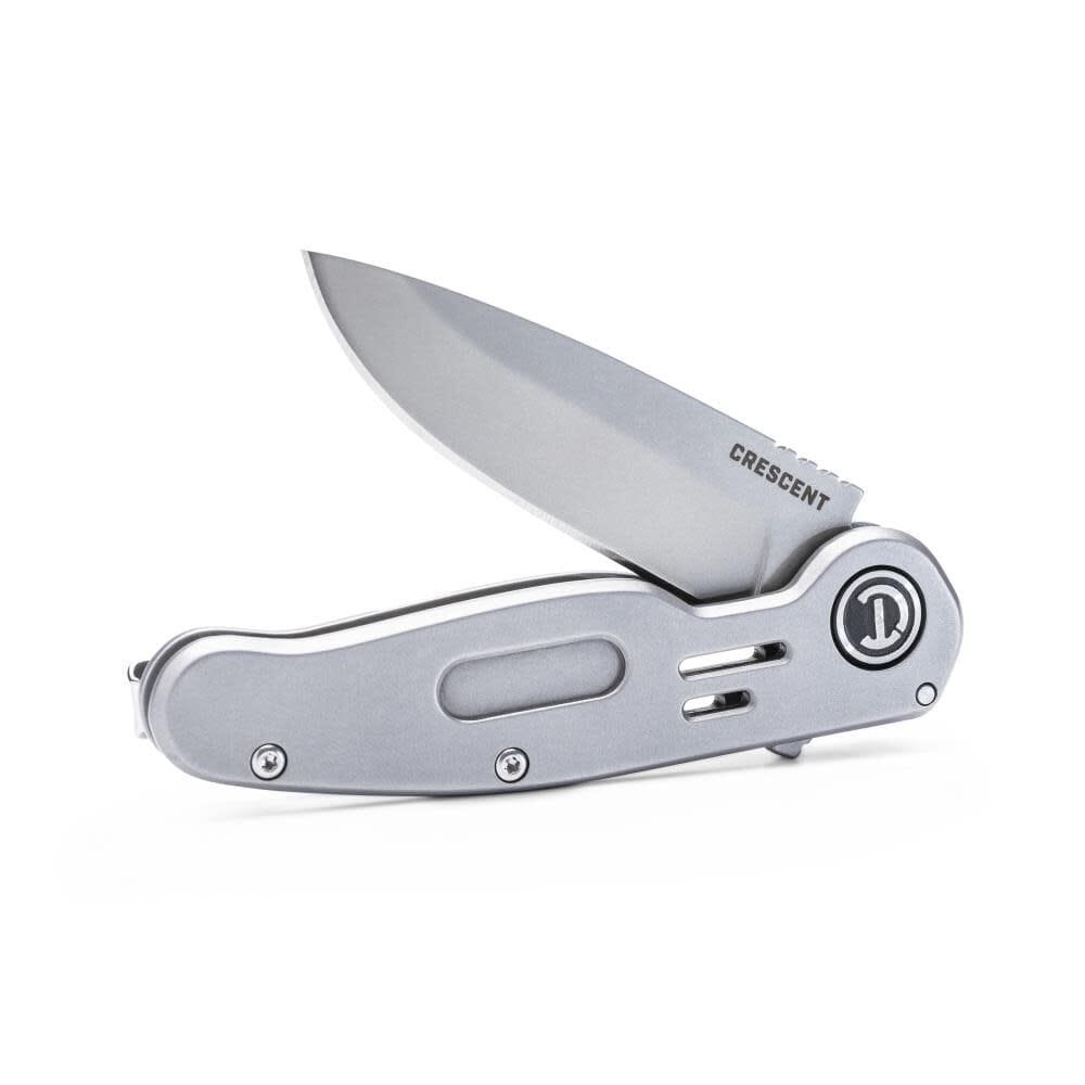 An alternate low-angle studio view of the Crescent folding pocket knife standing partially open on its steel handle frame, showcasing the rugged stone-washed drop point blade finish and sleek low-profile handle geometry.