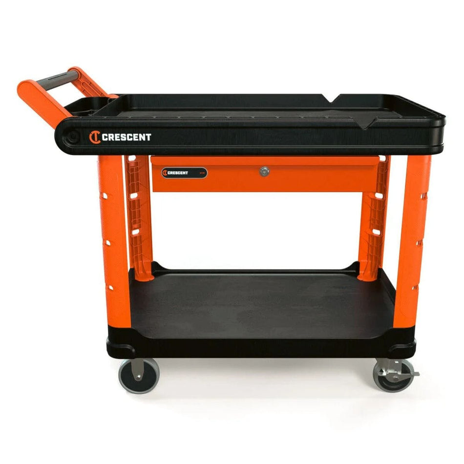 A professional product shot of the Crescent RAILWORKS 2-shelf industrial utility cart in rawhide orange and black, featuring an integrated lockable tool drawer, structural foam shelves, and 5-inch heavy-duty casters.