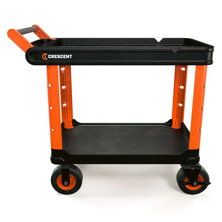 A studio profile view of the Crescent RAILWORKS IUC2S8CBM industrial utility cart. The image showcases the heavy-duty two-shelf design with high-visibility rawhide orange legs, black structural foam shelves, and oversized 8-inch all-terrain semi-pneumatic casters for superior jobsite mobility.