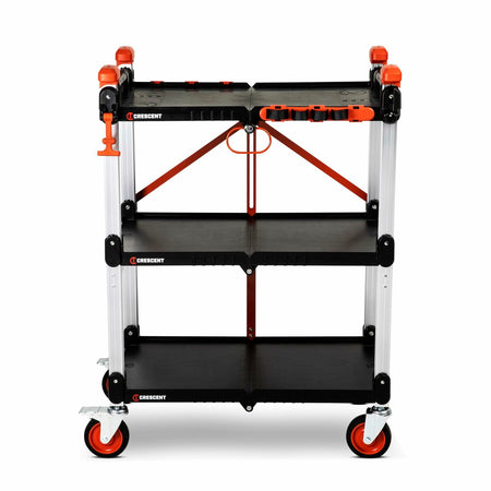 Three-tier Crescent jobsite cart with black shelves, aluminum posts, and red accents. The top shelf includes molded compartments for organizing tools. The cart has four caster wheels, two with brakes, and a side handle for mobility. “Crescent” branding is visible on each shelf.