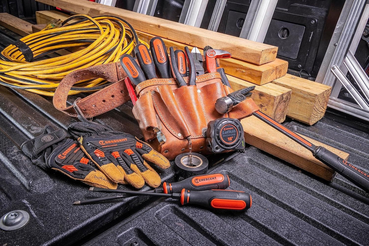 Crescent diamond-tip screwdrivers organized in a leather tool pouch on a jobsite truck bed alongside contractor hand tools.