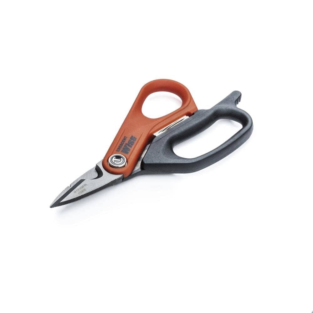 An angled perspective of the Crescent electrician scissors, highlighting the precision-ground titanium blades and the specialized cable cutter notch for industrial electrical work.