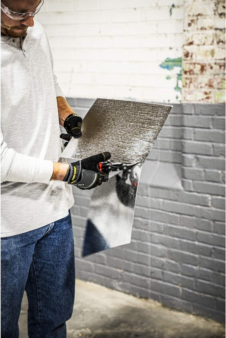A professional contractor using the 9-3/4 inch MetalMaster snips to cut a large sheet of metal, showcasing the tool's effectiveness in commercial HVAC and fabrication applications.