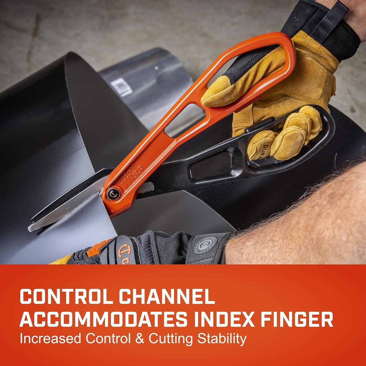 Action shot showing a gloved user utilizing the integrated control channel of the Crescent Wiss aluminum tinner snips to maintain stability while making a long straight cut through a sheet of black metal.