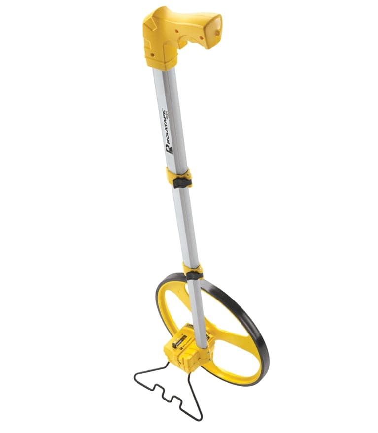 A front-angle view of the Cst/Berger RT312 measuring wheel, showing the yellow spoked wheel, the counter, the telescopic handle, and the black metal kickstand deployed to keep it standing upright.