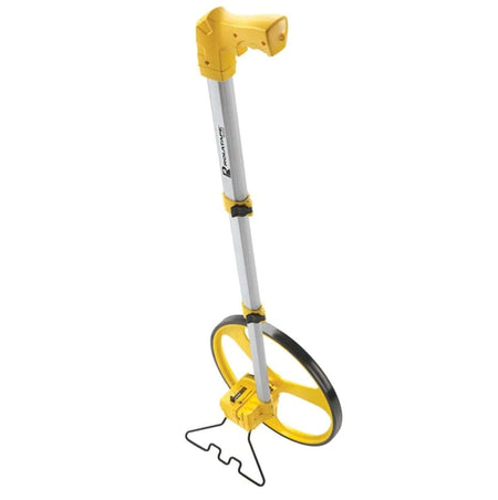 A front-angle view of the Cst/Berger RT312 measuring wheel, showing the yellow spoked wheel, the counter, the telescopic handle, and the black metal kickstand deployed to keep it standing upright.