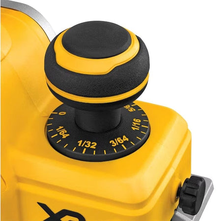 Close-up of depth adjustment knob on DEWALT DCP580B cordless planer showing fractional inch markings for precise cutting depth control.