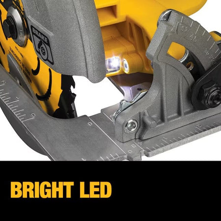 Close-up of DeWalt circular saw with illuminated LED light near blade. Metal base plate includes measurement markings.