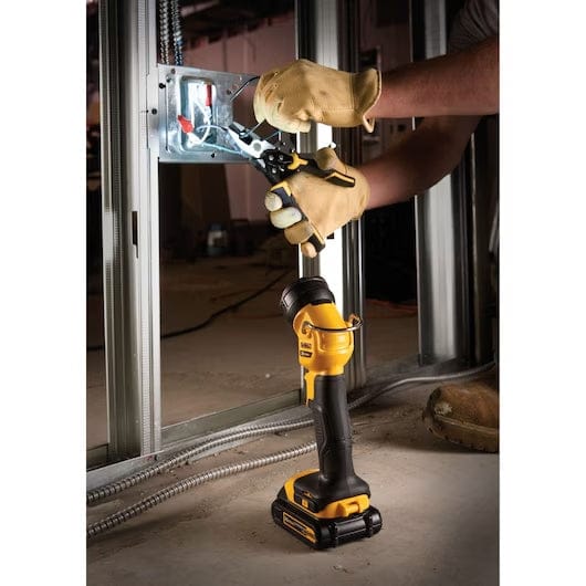 DEWALT DCL040 LED work light placed on a gray tiled surface. The yellow and black flashlight features a rotating head, integrated hook, and visible battery pack for cordless operation.