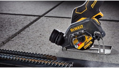 DEWALT cordless cut-off tool in use on a concrete surface near steel rebar, demonstrating metal and masonry cutting capabilities in a construction setting.
