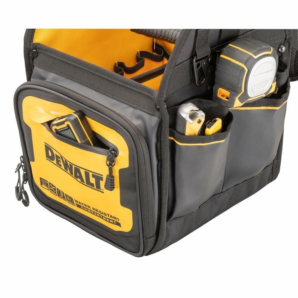 Close-up of a DEWALT tool tote bag with a black carabiner clip holding a keyring with three keys. The clip is attached to a fabric loop on the bag, which features reinforced stitching and multiple compartments for tool storage.