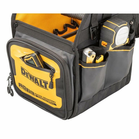 Close-up of a DEWALT tool tote bag with a black carabiner clip holding a keyring with three keys. The clip is attached to a fabric loop on the bag, which features reinforced stitching and multiple compartments for tool storage.