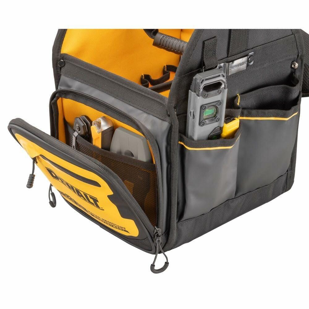Close-up of a DEWALT tool tote bag with a black carabiner clip holding a keyring with three keys. The clip is attached to a fabric loop on the bag, which features reinforced stitching and multiple compartments for tool storage.
