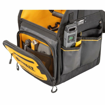 Close-up of a DEWALT tool tote bag with a black carabiner clip holding a keyring with three keys. The clip is attached to a fabric loop on the bag, which features reinforced stitching and multiple compartments for tool storage.