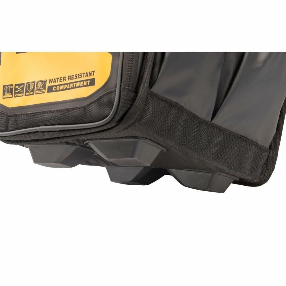 Close-up of the bottom and side of a DEWALT tool tote bag featuring a molded plastic base and yellow side panel labeled “WATER RESISTANT COMPARTMENT.” Multiple pockets and icons highlight the bag’s durability and organizational features.