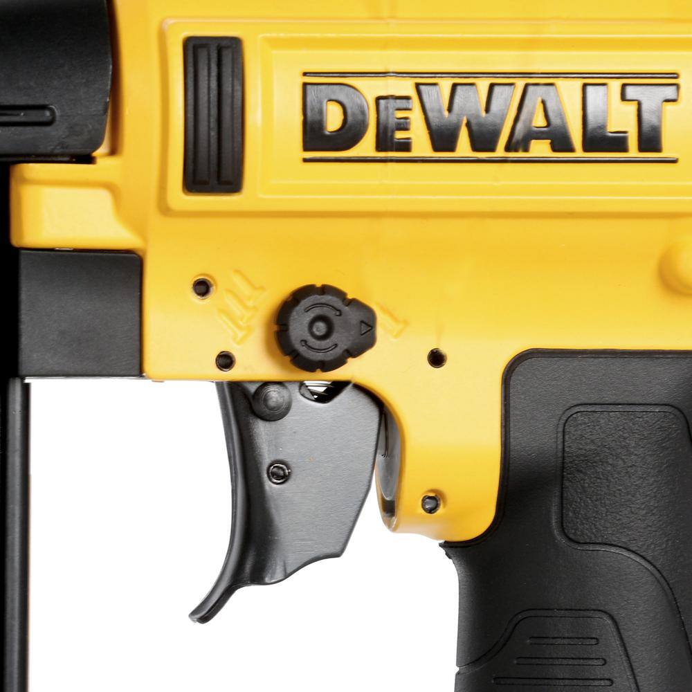 Detail of the tool-free depth adjustment wheel located on the side of the DEWALT 18 gauge nailer for precise control of nail head countersinking.