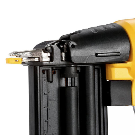 Technical shot of the top of the DEWALT pneumatic nailer highlighting the tool-free jam release lever for quick clearing of fasteners during trim work.