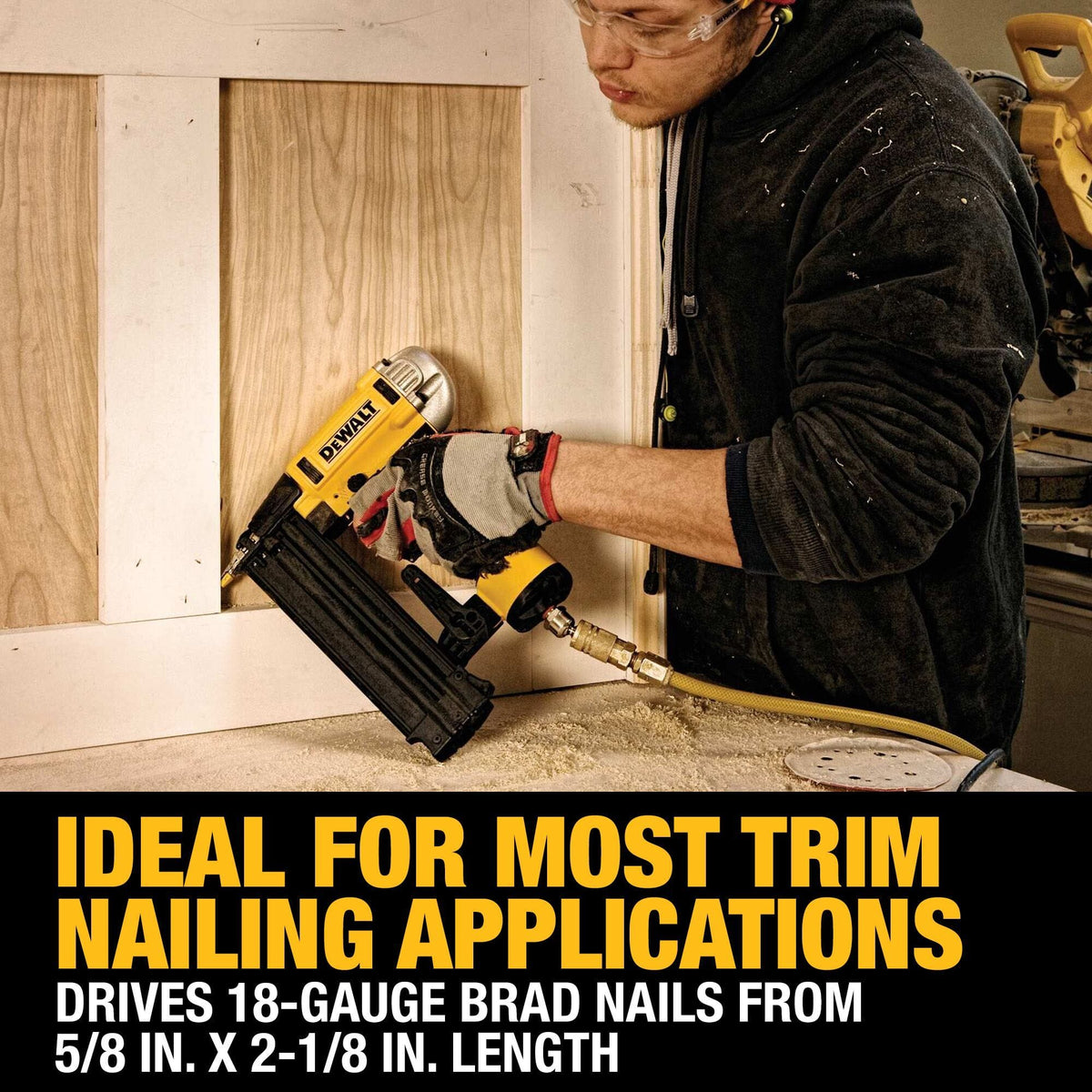 Action shot of a carpenter using the DEWALT Precision Point brad nailer for interior trim application demonstrating the tool's 18 gauge fastening range on a wood wall panel.