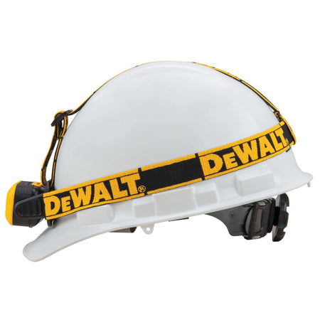 Side profile of a white hard hat with the DEWALT jobsite headlamp installed illustrating the secure fit and low-profile attachment for professional construction use.