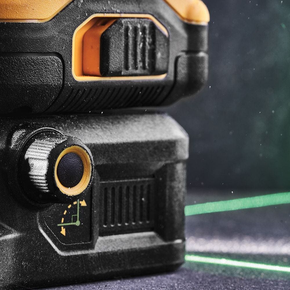 Close-up of the DEWALT cross line laser level fine adjustment knob for precise alignment of the green laser beams on a dark textured background.
