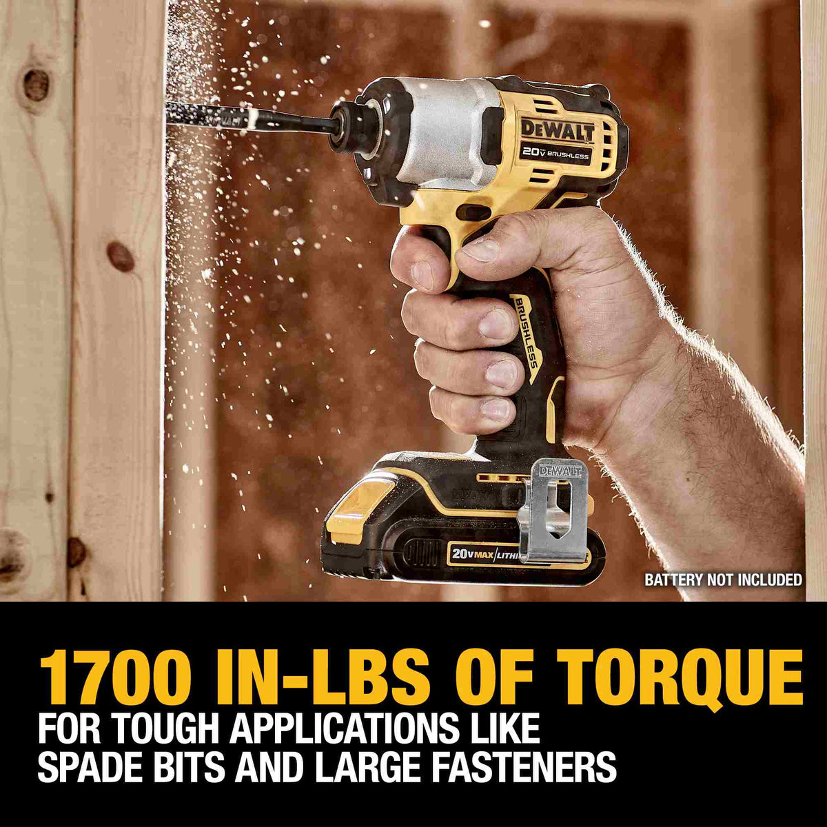 Close-up action shot of the DEWALT ATOMIC impact driver delivering 1,700 in-lbs of torque while driving a large fastener into a wood stud. The image highlights the tool's high-torque capability for tough applications like spade bits and heavy-duty fastening.