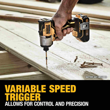 Action view of the DEWALT 20V MAX brushless impact driver being used to drive a screw into a pressure-treated deck board. Text overlay emphasizes the variable speed trigger which allows for maximum control and precision during delicate or high-speed tasks.v