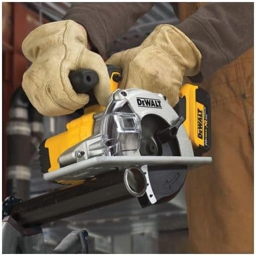 Person wearing heavy-duty gloves holding a DEWALT cordless circular saw in a workshop setting, showcasing tool grip and branding.