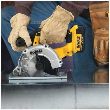 User cutting through sheet metal with a DEWALT 20V MAX XR circular saw, demonstrating tool performance and safe handling in a construction environment.
