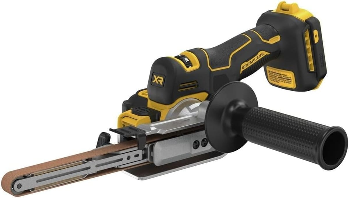 Angled side view of the DEWALT DCM200B 20V MAX XR brushless bandfile sander. The image highlights the rugged construction and compact design of the 18-inch cordless belt sander, optimized for reaching tight spaces in commercial metal applications.
