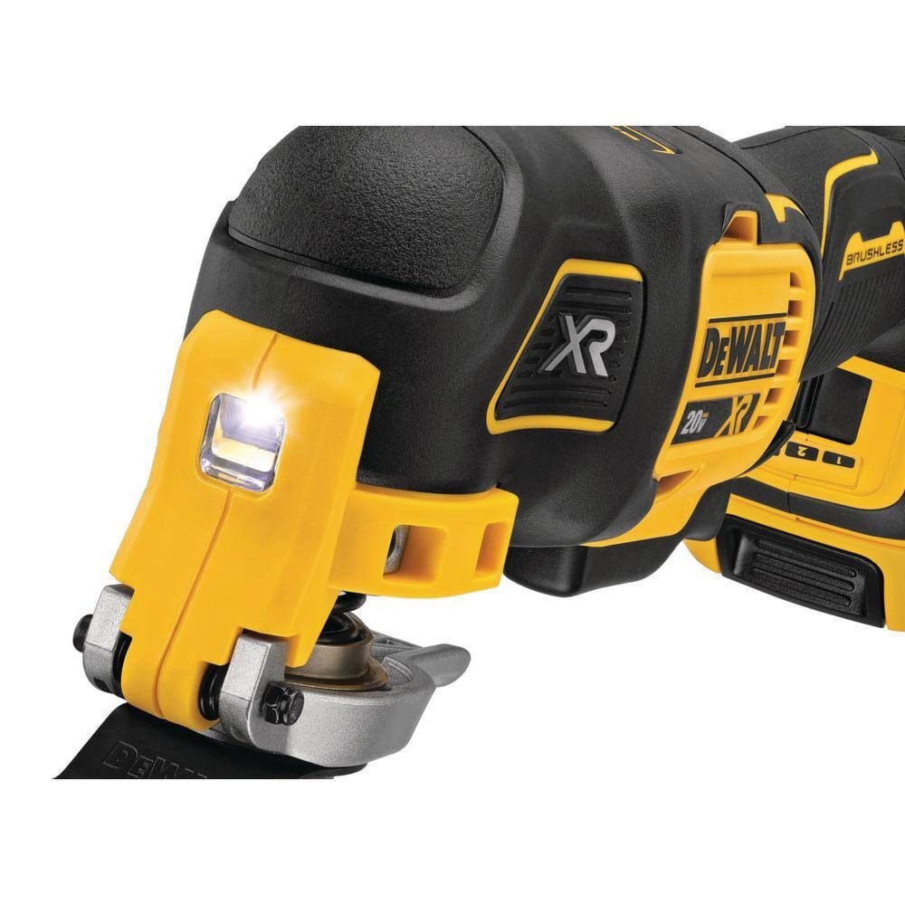A close-up view of the front of the DEWALT oscillating multi-tool focusing on the integrated bright LED work light and the tool-free Quick-Change accessory system for fast blade swaps.