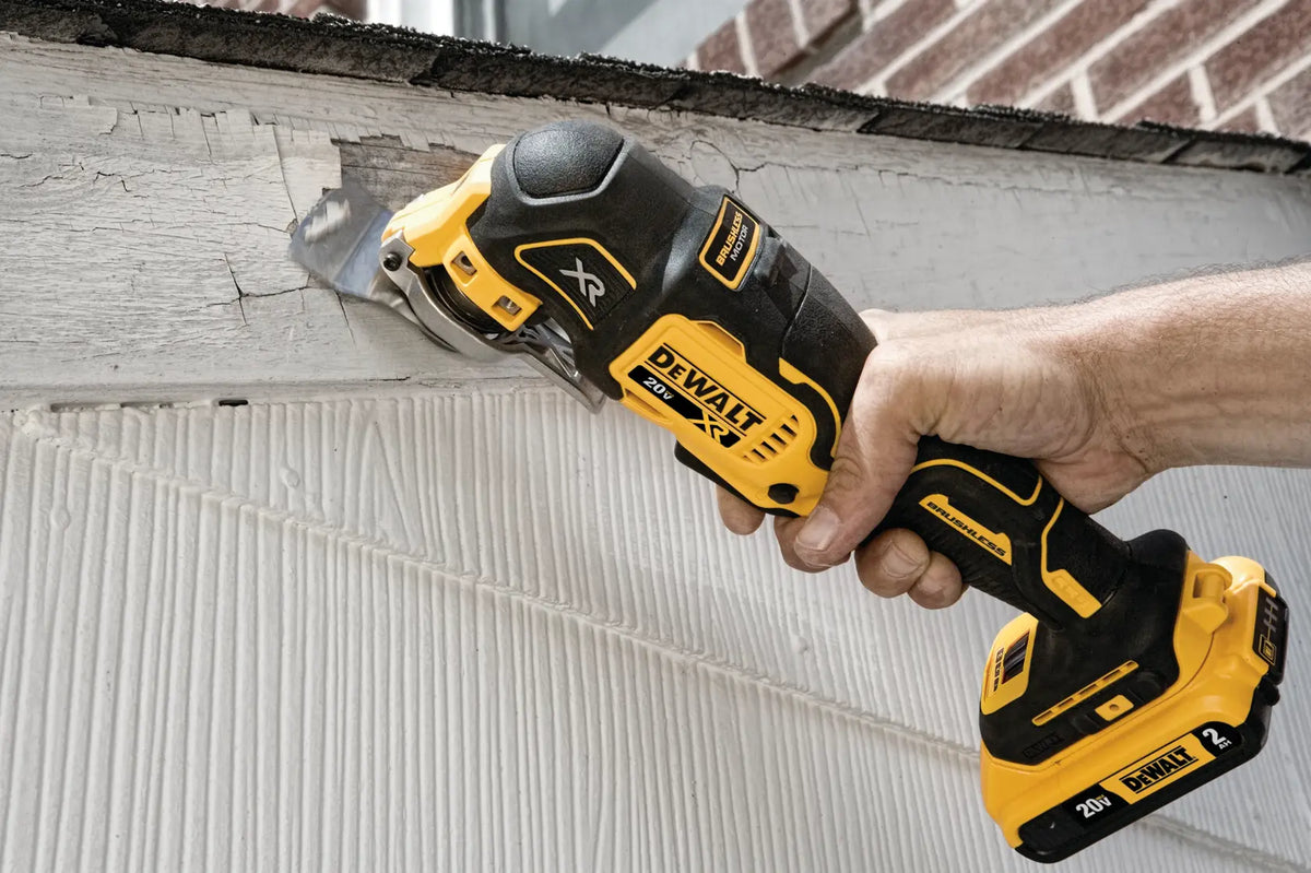 DEWALT 20V MAX XR Brushless Oscillating Multi‑Tool DCS356 sanding or scraping a damaged wooden surface, highlighting cordless versatility for renovation and surface preparation tasks.